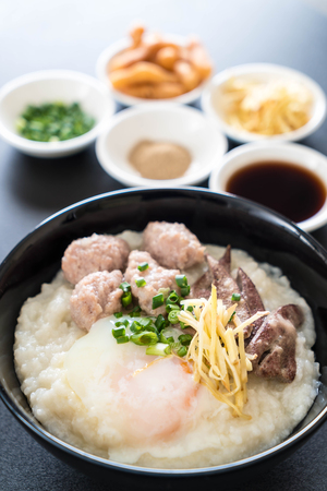 rice porridge with pork and egg with ingredientの写真素材