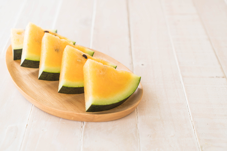 fresh yellow watermelon on woodの写真素材