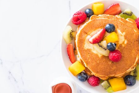 pancake with mix fruits (strawberry, blueberries, raspberries, mango, kiwi)の写真素材