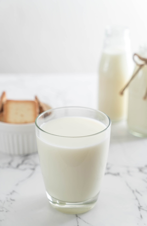 glass of fresh milk on the tableの写真素材