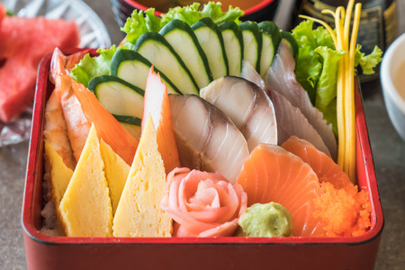Raw fresh sashimi with rice in bento box - japanese food styleの写真素材