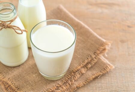 glass of fresh milk on the tableの写真素材