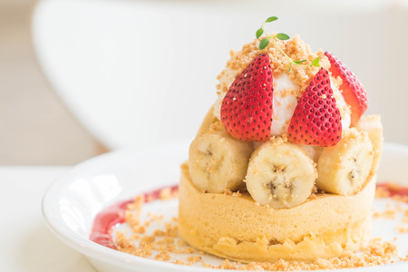 hot cake with cream, strawberry, banana and cookie crumble - dessertの写真素材