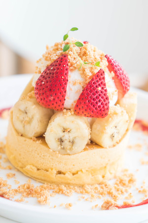 hot cake with cream, strawberry, banana and cookie crumble - dessertの写真素材