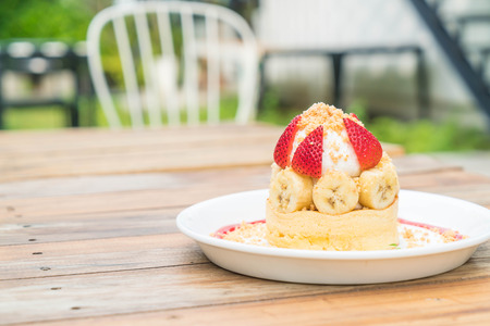 hot cake with cream, strawberry, banana and cookie crumble - dessertの写真素材
