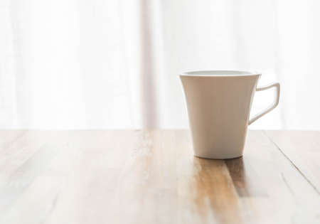 a coffee cup on wood tableの写真素材
