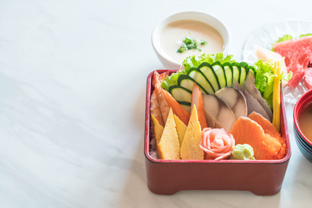 Raw fresh sashimi with rice in bento box - japanese food styleの写真素材