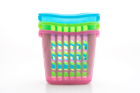 colorful plastic basket isolated on white backgroundの写真素材