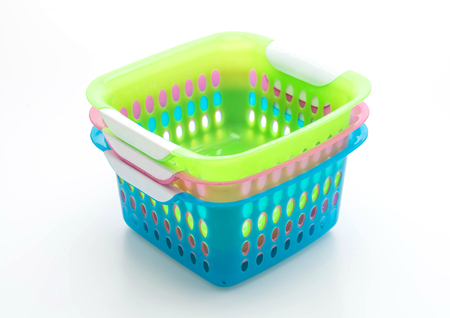 colorful plastic basket isolated on white backgroundの写真素材