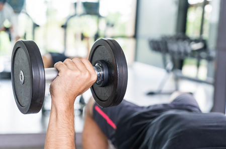 Close-up Hand holding dumbbell in gymの写真素材