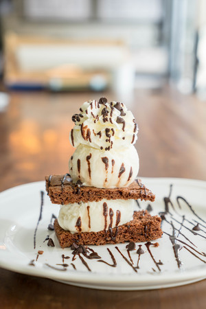 chocolate brownies with vanilla ice-cream and whipped creamの写真素材