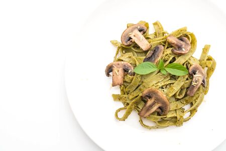 spinach fettuccine with mushroom isolated on white backgroundの写真素材