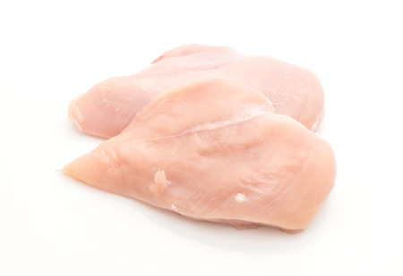 fresh raw chicken breast fillet isolated on white backgroundの写真素材