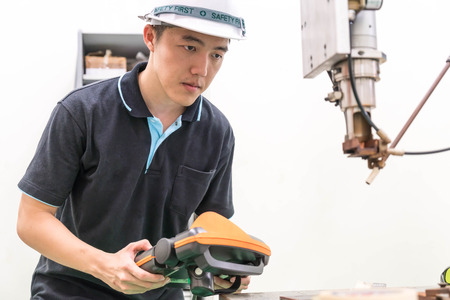 Electrical engineer working with a robot machine