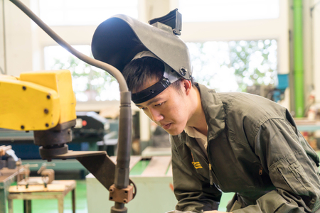 Electrical engineer working with a robot machine