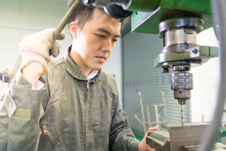Electrical engineer working with a robot machine