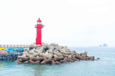 red lighthouse in Jeju Island, South Koreaの写真素材