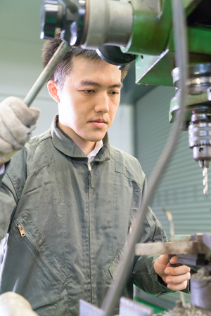 Electrical engineer working with a robot machineの写真素材