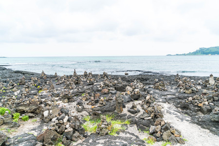 stone towers on basaltic rocks at Hyeopjae Beach,Jeju Island, South Koreaの写真素材