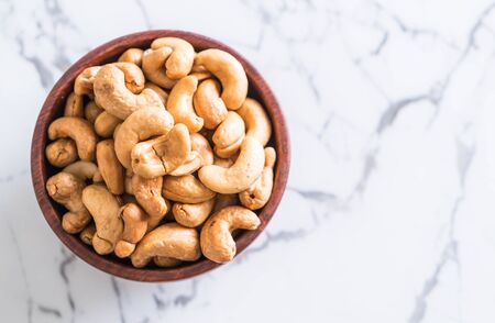 Roasted cashew nuts in bowlの写真素材