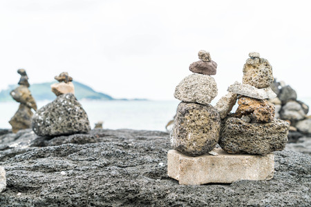 stone towers on basaltic rocks at Hyeopjae Beach,Jeju Island, South Koreaの写真素材