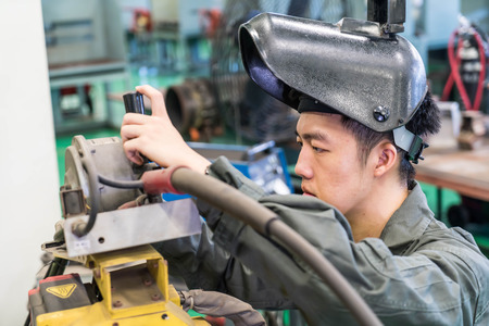 Electrical engineer working with a robot machineの写真素材
