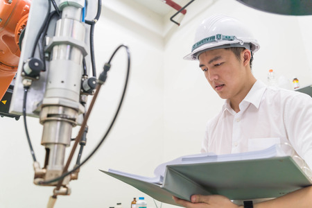 Electrical engineer working with a robot machine