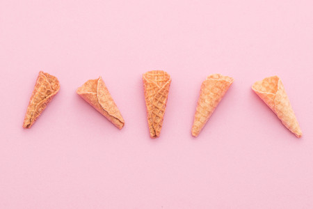 empty wafer cone on pink background