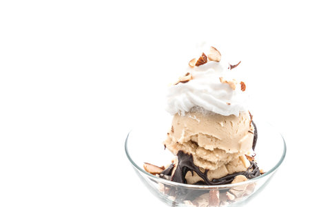 vanilla ice cream with chocolate and whipped cream isolated on white backgroundの写真素材