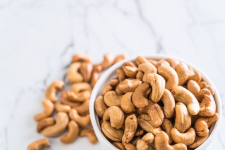 Roasted cashew nuts in bowlの写真素材
