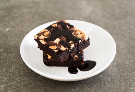 chocolate brownies with chocolate sauce on the tableの写真素材