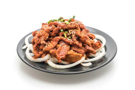 fried pork with spicy korean sauce (bulgogi) isolated on white backgroundの写真素材