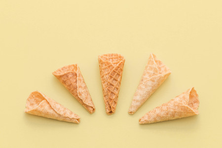 empty wafer cone on yellow backgroundの写真素材
