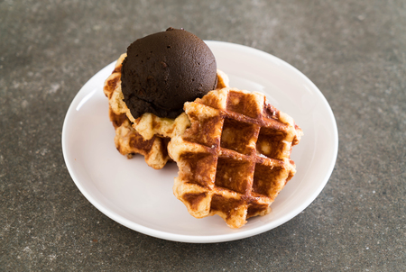 waffle with chocolate ice cream on the tableの写真素材
