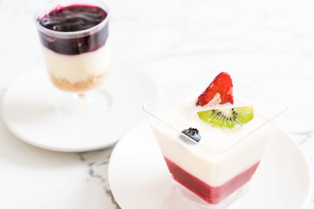 panna cotta with strawberry sauce on tableの写真素材