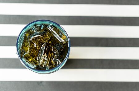a glass of cola on the tableの写真素材
