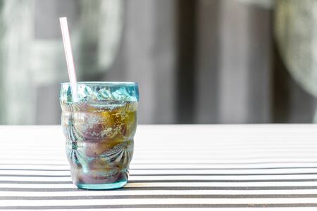 a glass of cola on the tableの写真素材