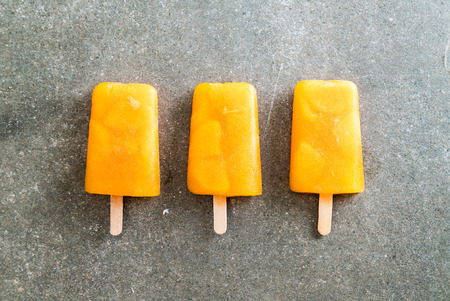 Homemade orange ice cream on a stickの写真素材