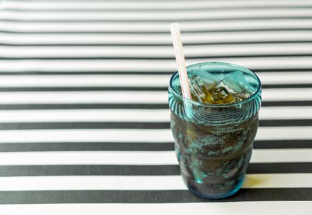 a glass of cola on the tableの写真素材