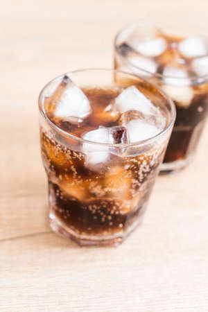 glass of cola with ice on the table