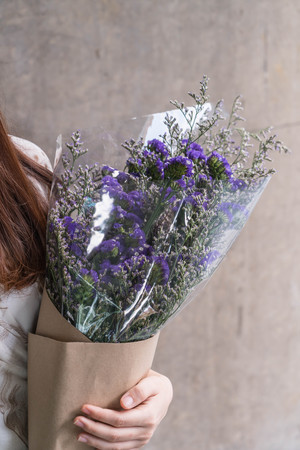 Hands holding bouquet of flower - vintage lighting style
