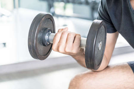 Close-up Hand holding dumbbell in gym