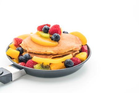 pancake with mix fruits (strawberry, blueberries, raspberries, mango, kiwi) on white backgroundの写真素材