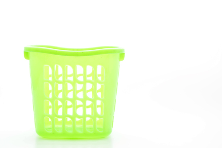 green plastic basket isolated on white backgroundの写真素材