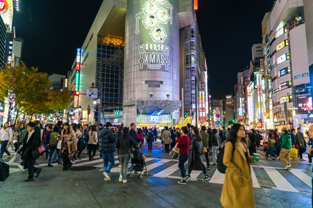 Tokyo, Japan, Nov 17, 2016: Shibuya Crossing Of City street with crowd people on zebra crosswalk in Shibuya town. Shibuya is a special ward located in Tokyo for shopping at night.