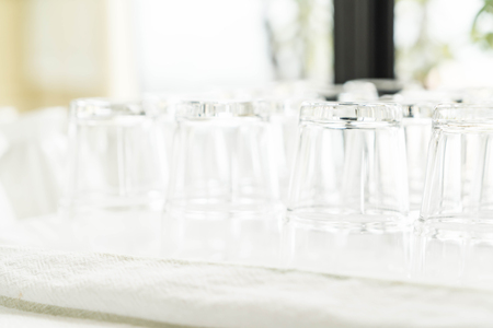 Stack of clear water glass bottom up - selective focus pointの写真素材