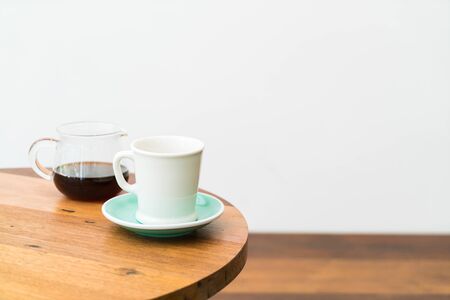 cup with hot coffee pot on tableの写真素材