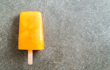 Homemade orange ice cream on a stickの写真素材