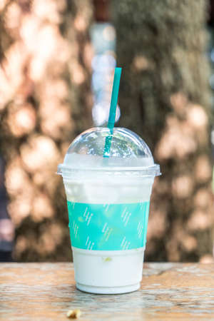 iced vanilla milkshake on wooden bar