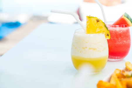 pineapple smoothies with sea backgroundの写真素材